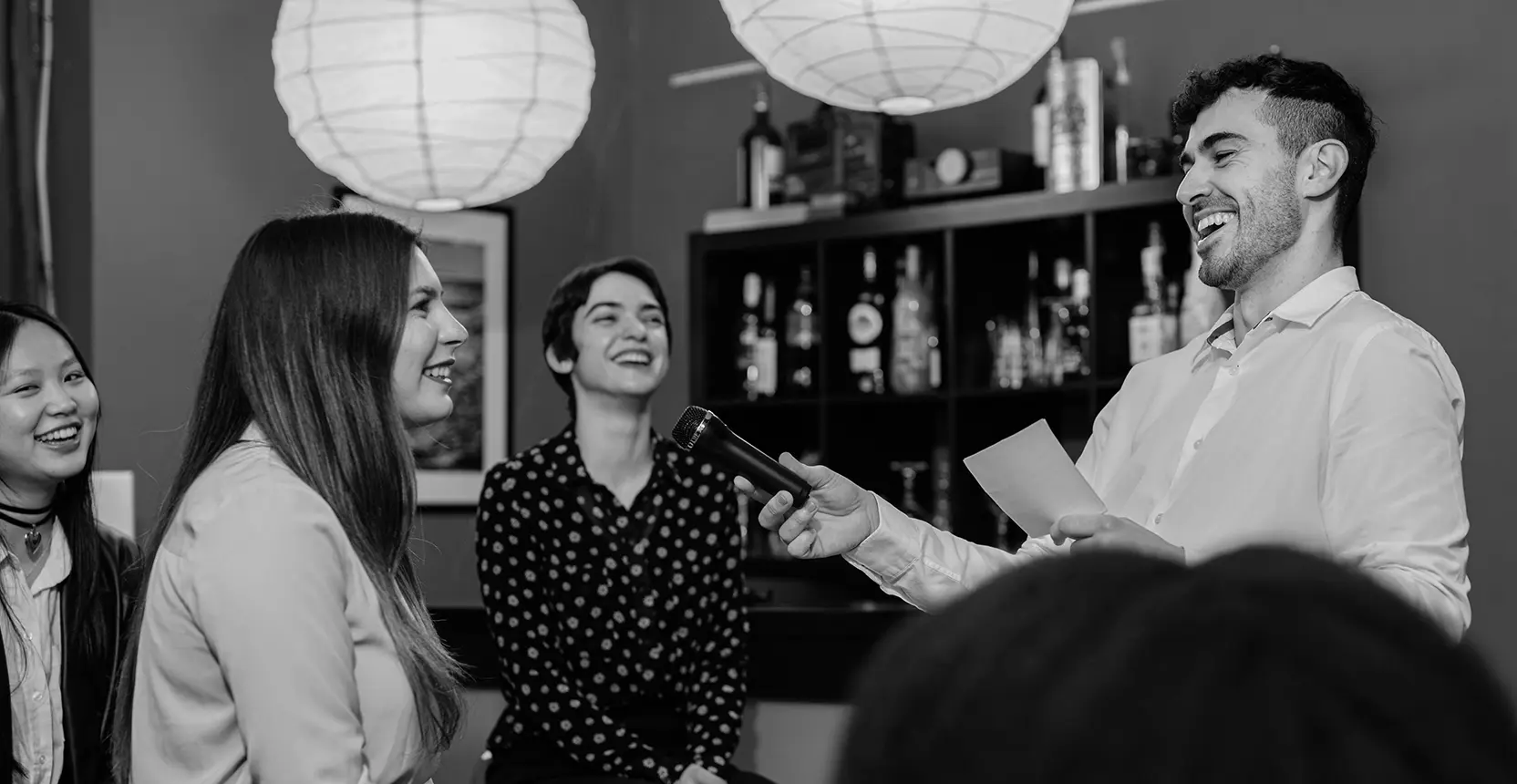 A No Cants member speaking into a microphone at a Quarterly networking session